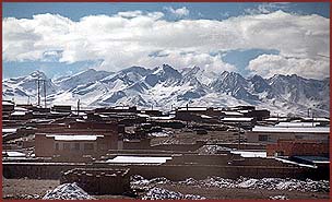 The snow covered buildings of El Alto with the Andes Mountains